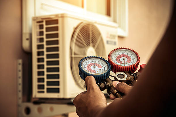 Professional Air Conditioning Service technician working in Fenton, IA